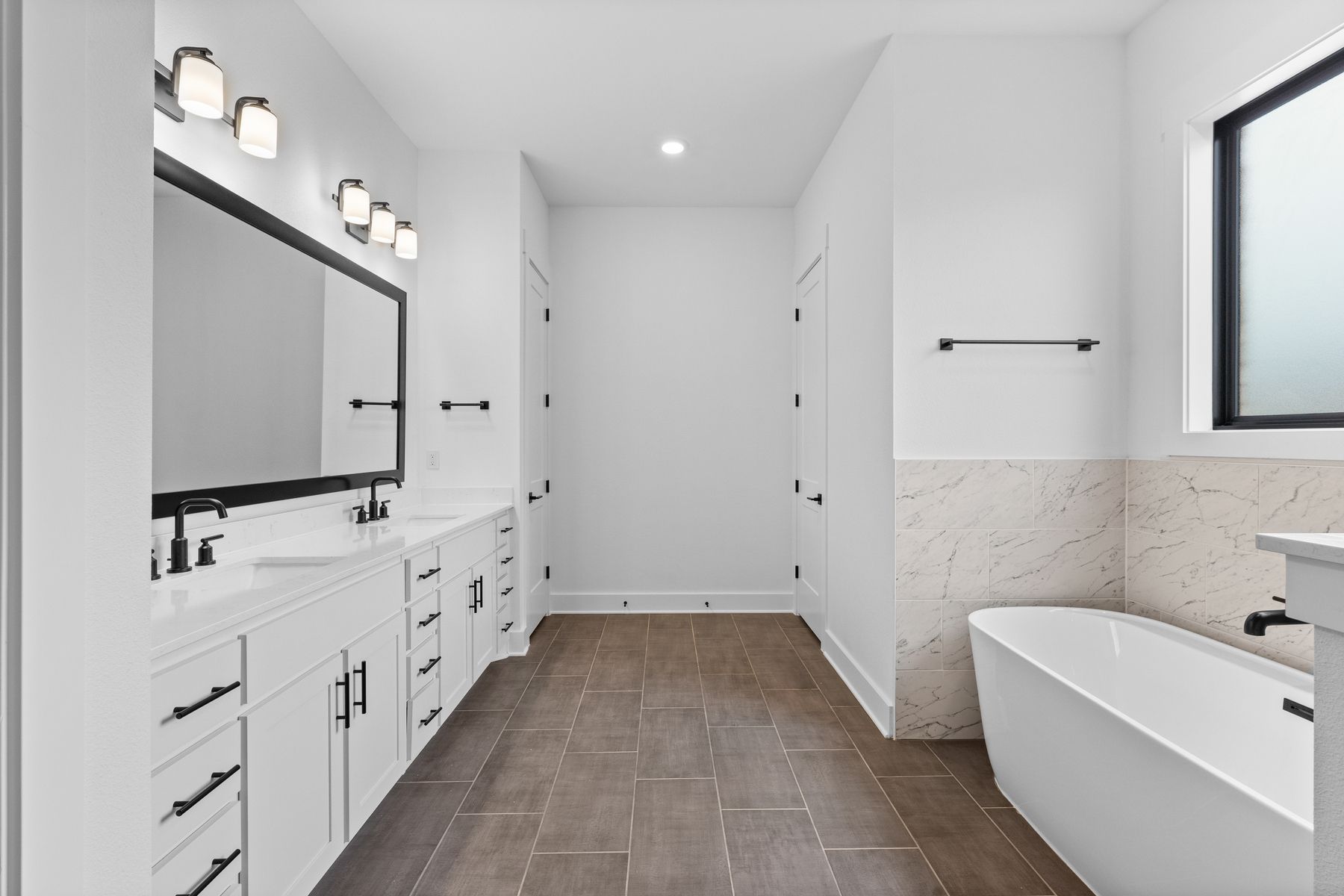 The gorgeous master bathroom has a large glass, walk-in shower and tub.