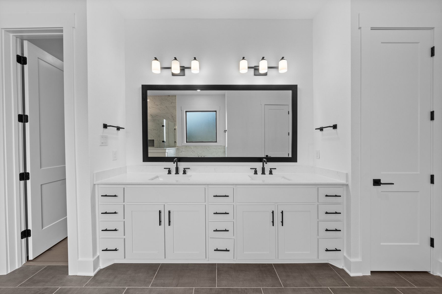 The gorgeous master bathroom has a giant vanity space that has two sinks and vanity space.