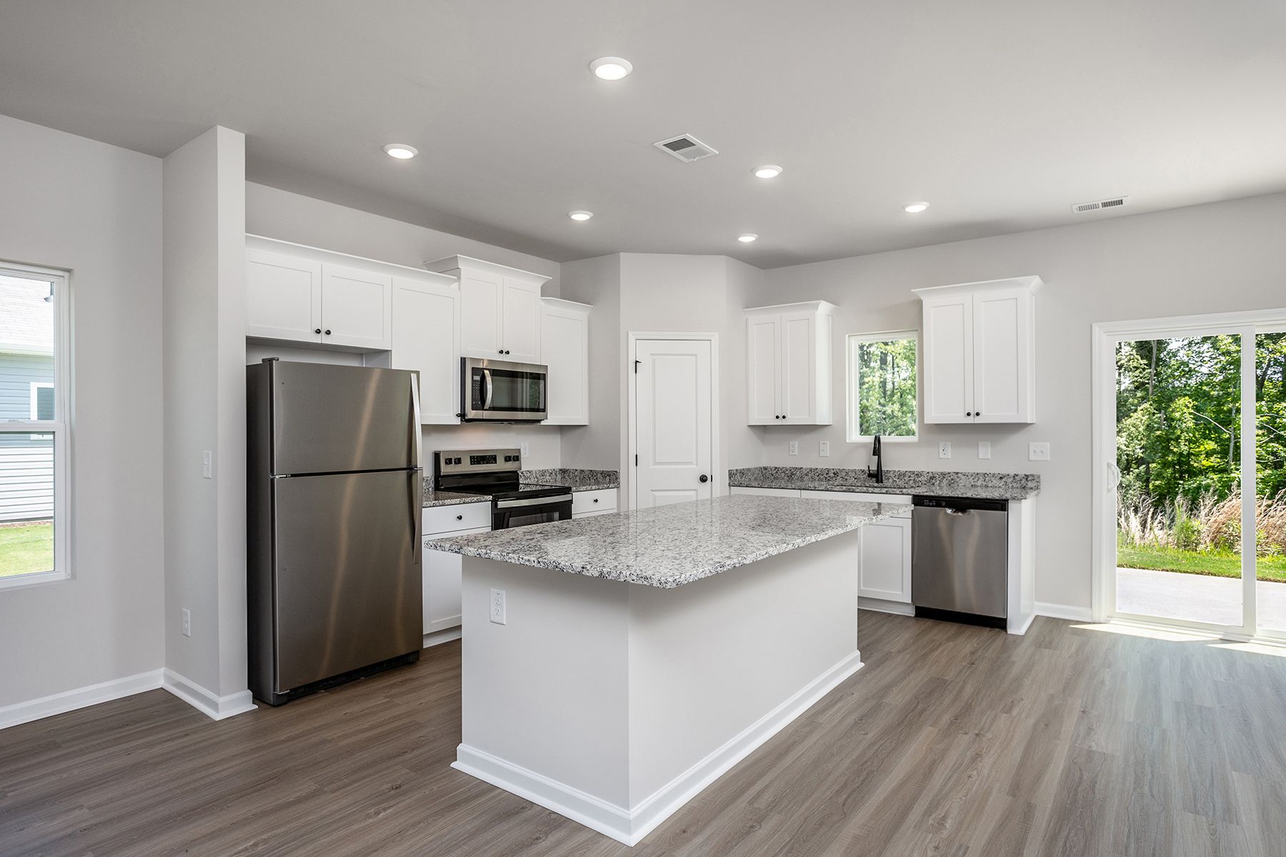 The kitchen has designer wood cabinetry