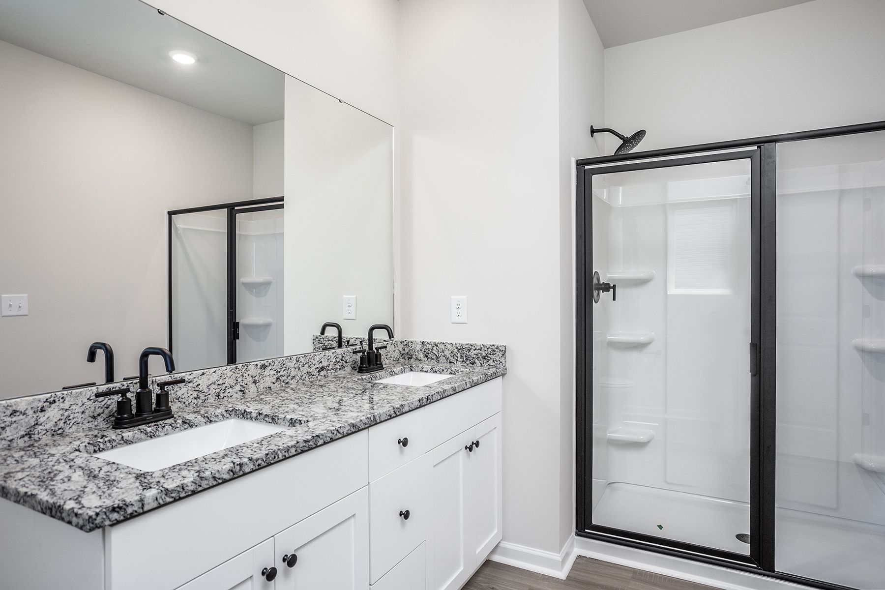 The master bathroom has a glass-enclosed shower