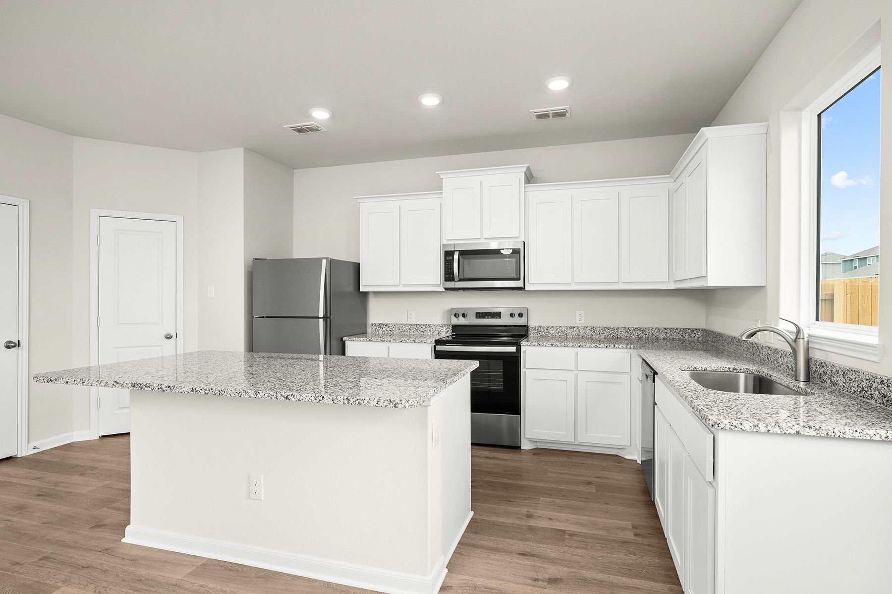 The kitchen has sprawling granite countertops.
