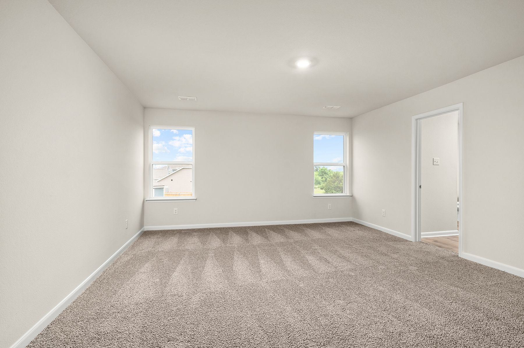 The master bedrooms has two large windows.