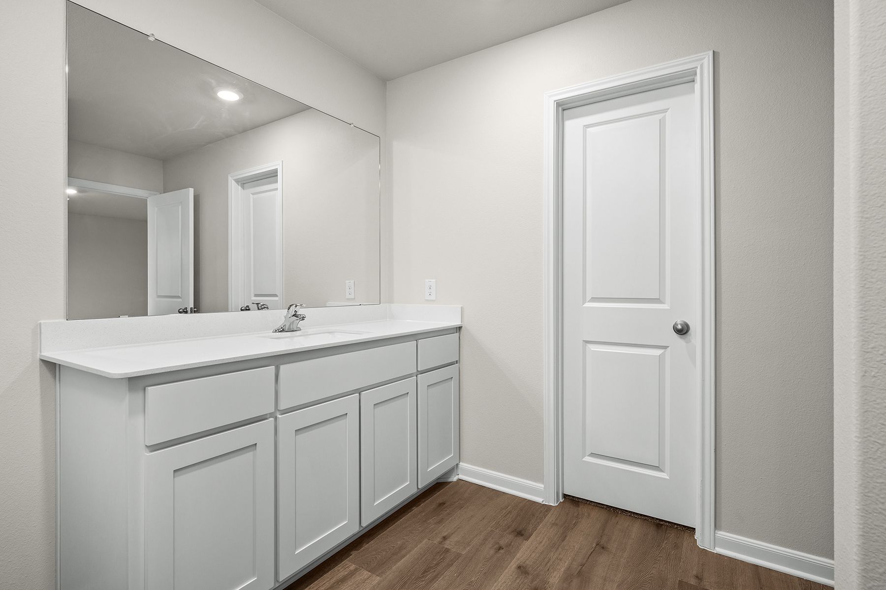 The master bathroom has a sprawling vanity space.
