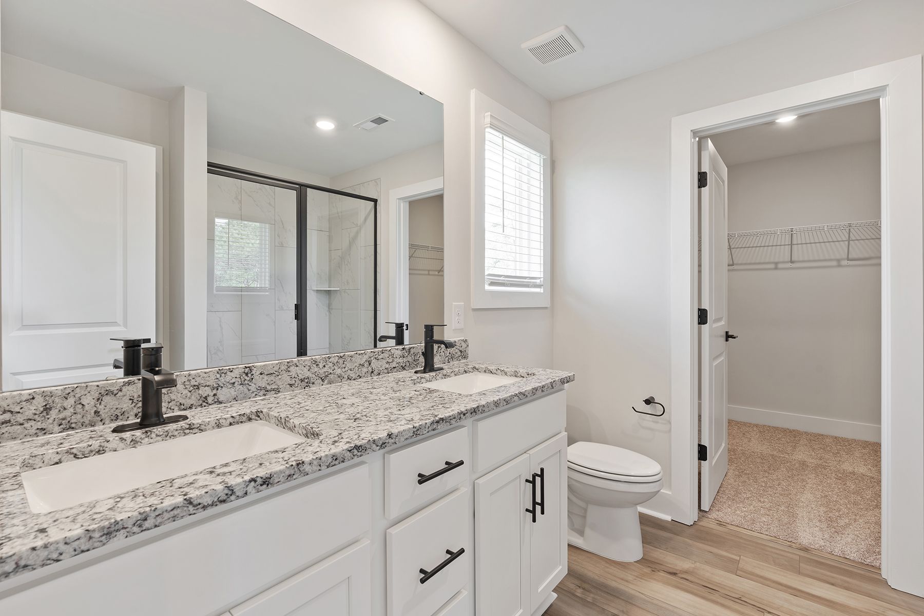 The master bathroom has a glass-enclosed shower