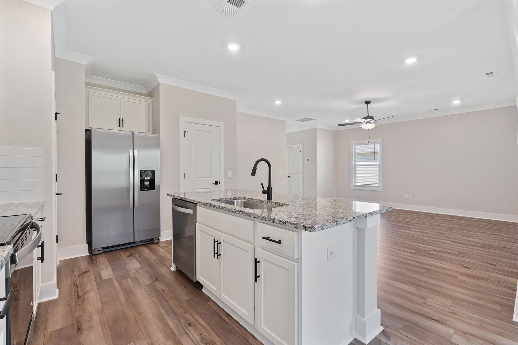 The kitchen has designer wood cabinetry