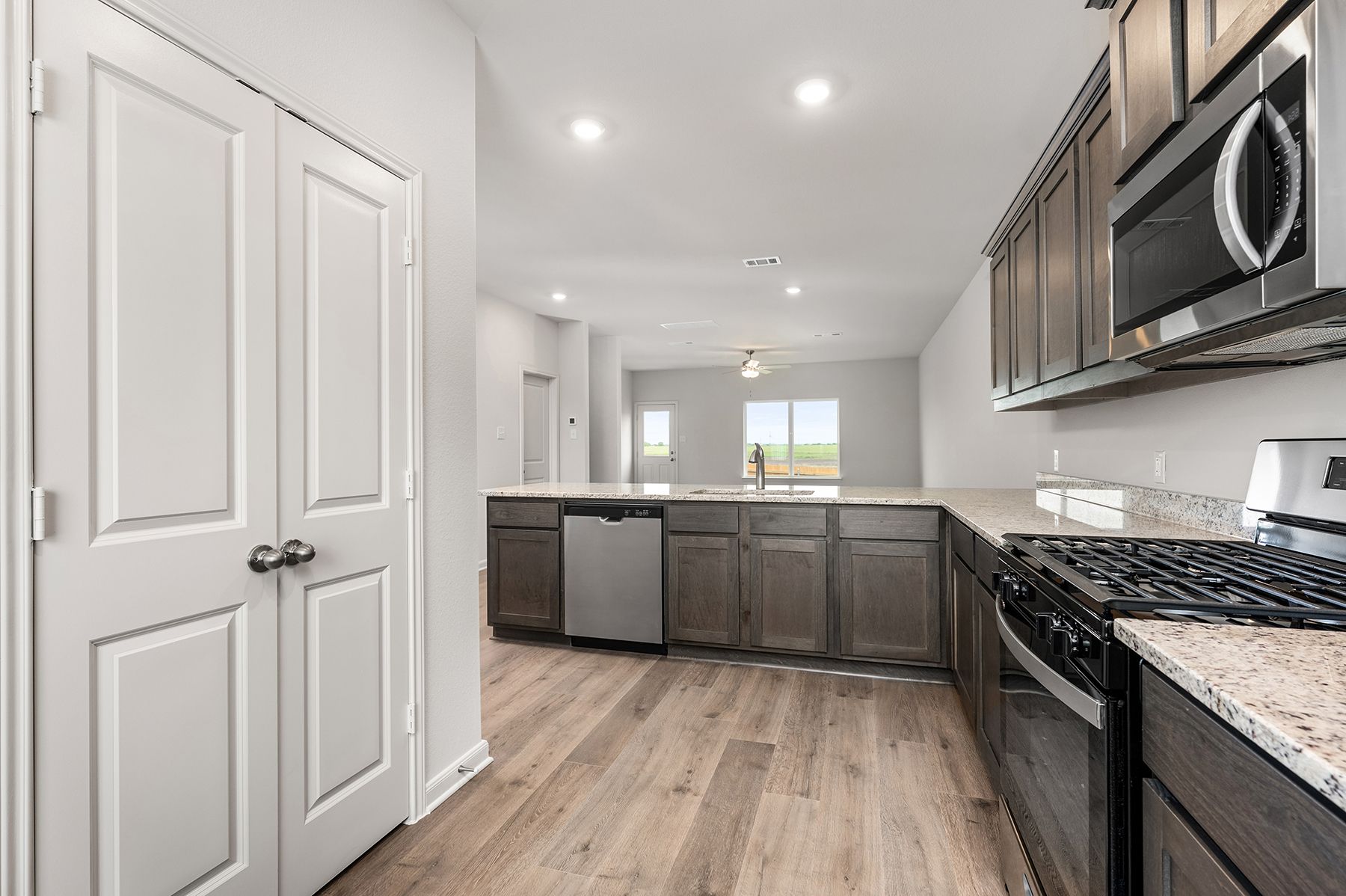 The kitchen looks out into the dining room and family room.