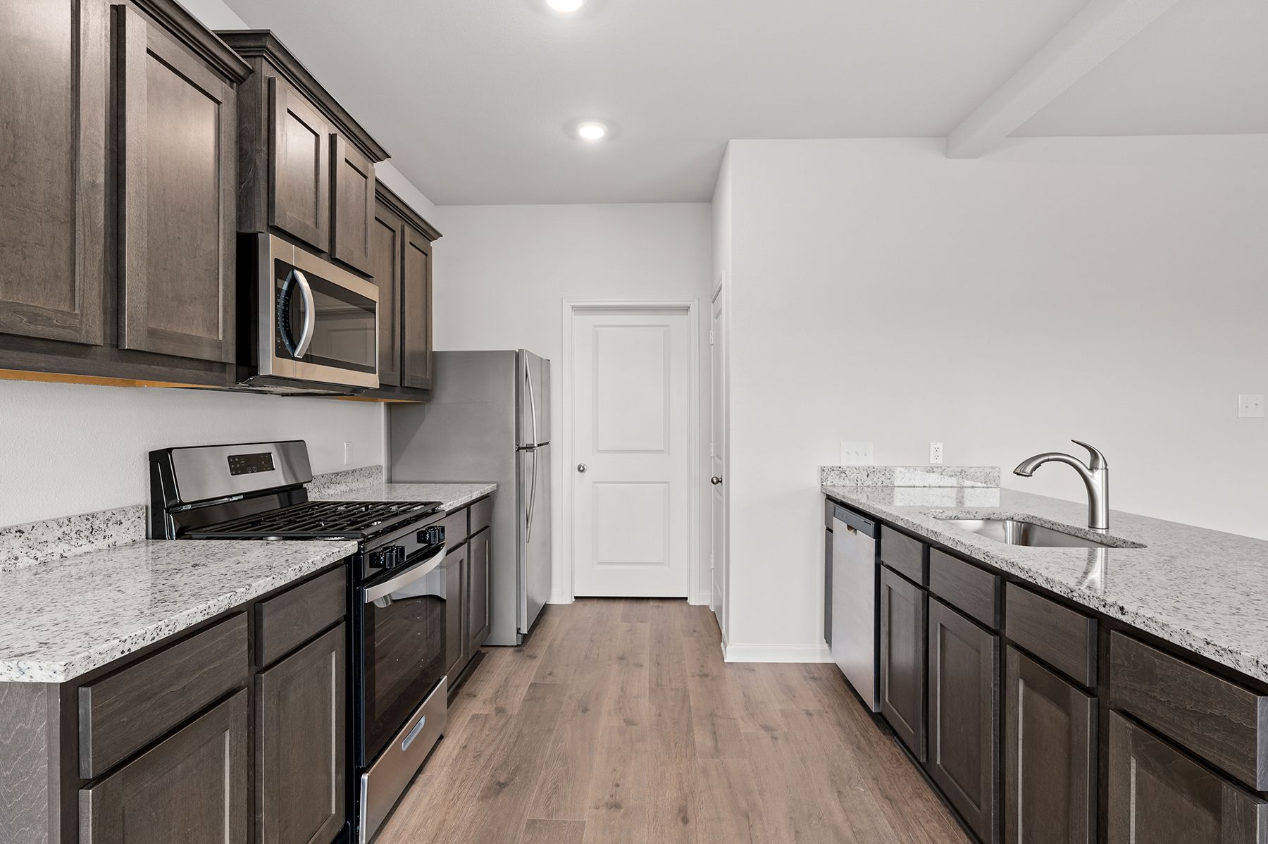 The kitchen has a beautiful wood cabinetry.