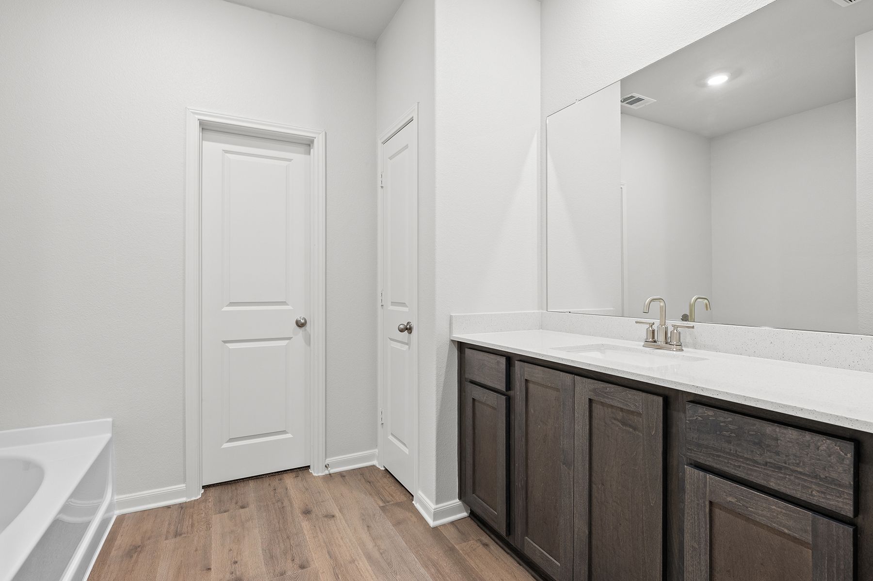 The master bathroom has a large vanity space.