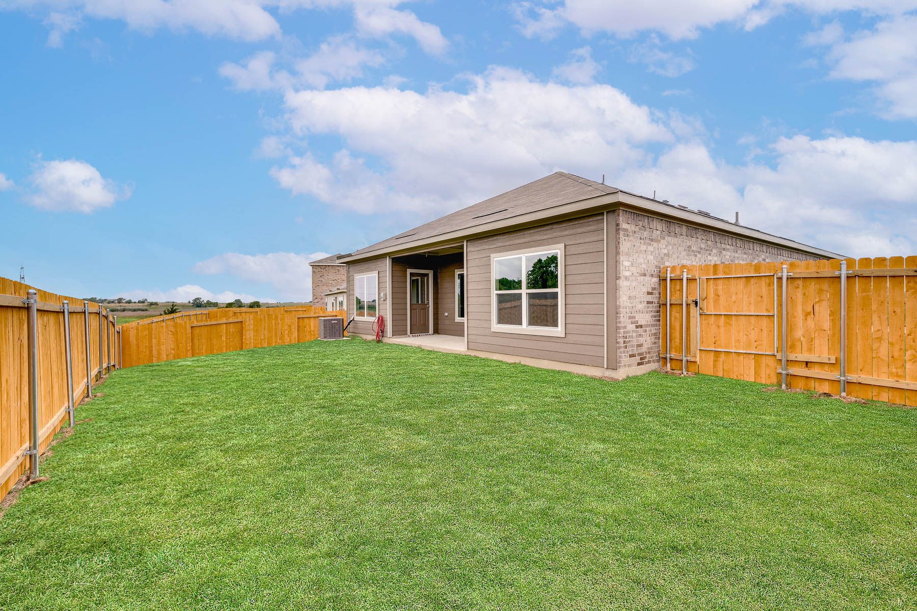 The back yard of the Blanco is fully fenced-in.