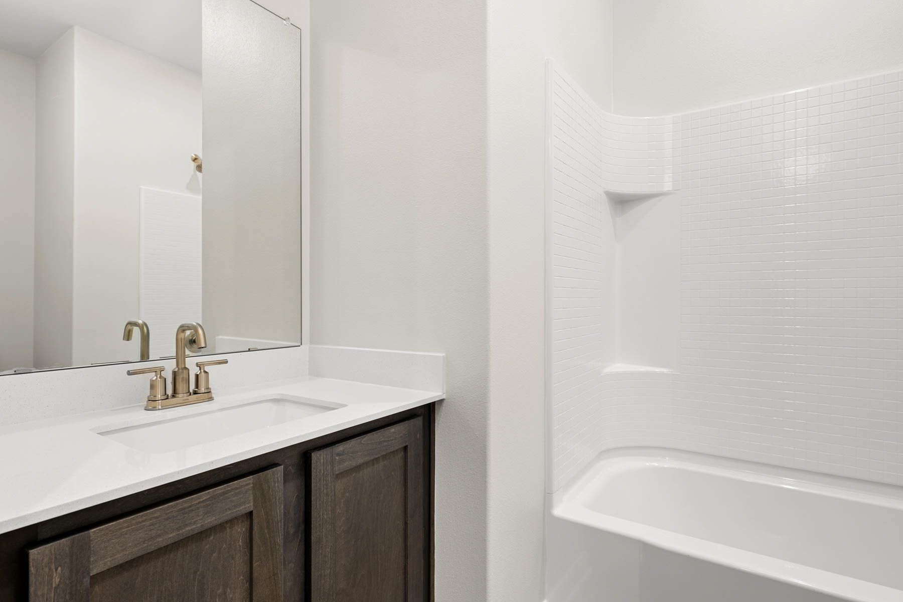 The secondary bathroom has a sprawling vanity space.