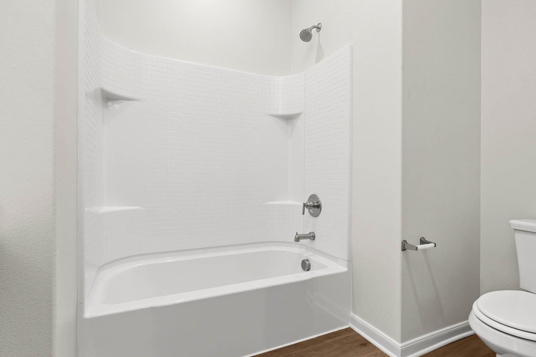 The secondary bathroom has a shower-tub combo.