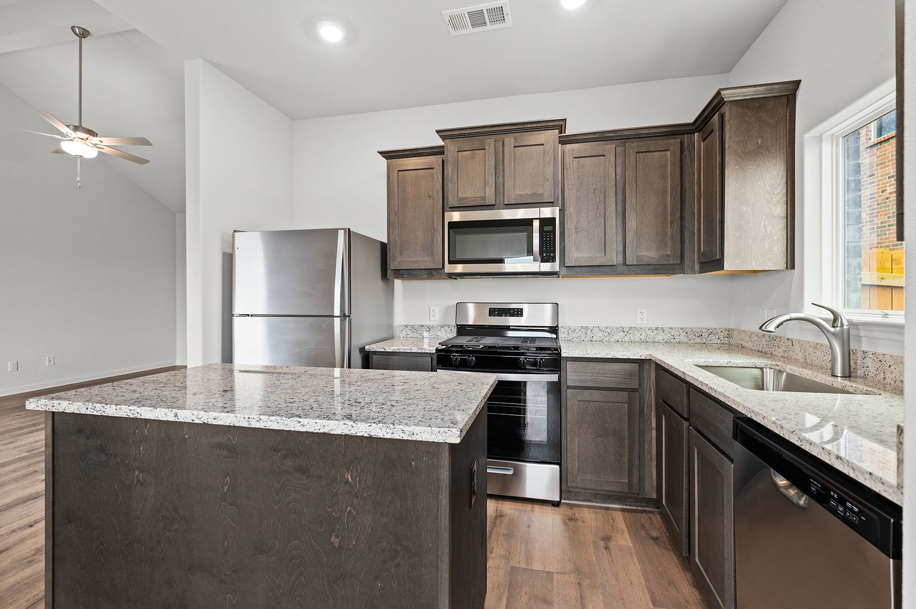 The kitchen has gorgeous wood cabinetry.