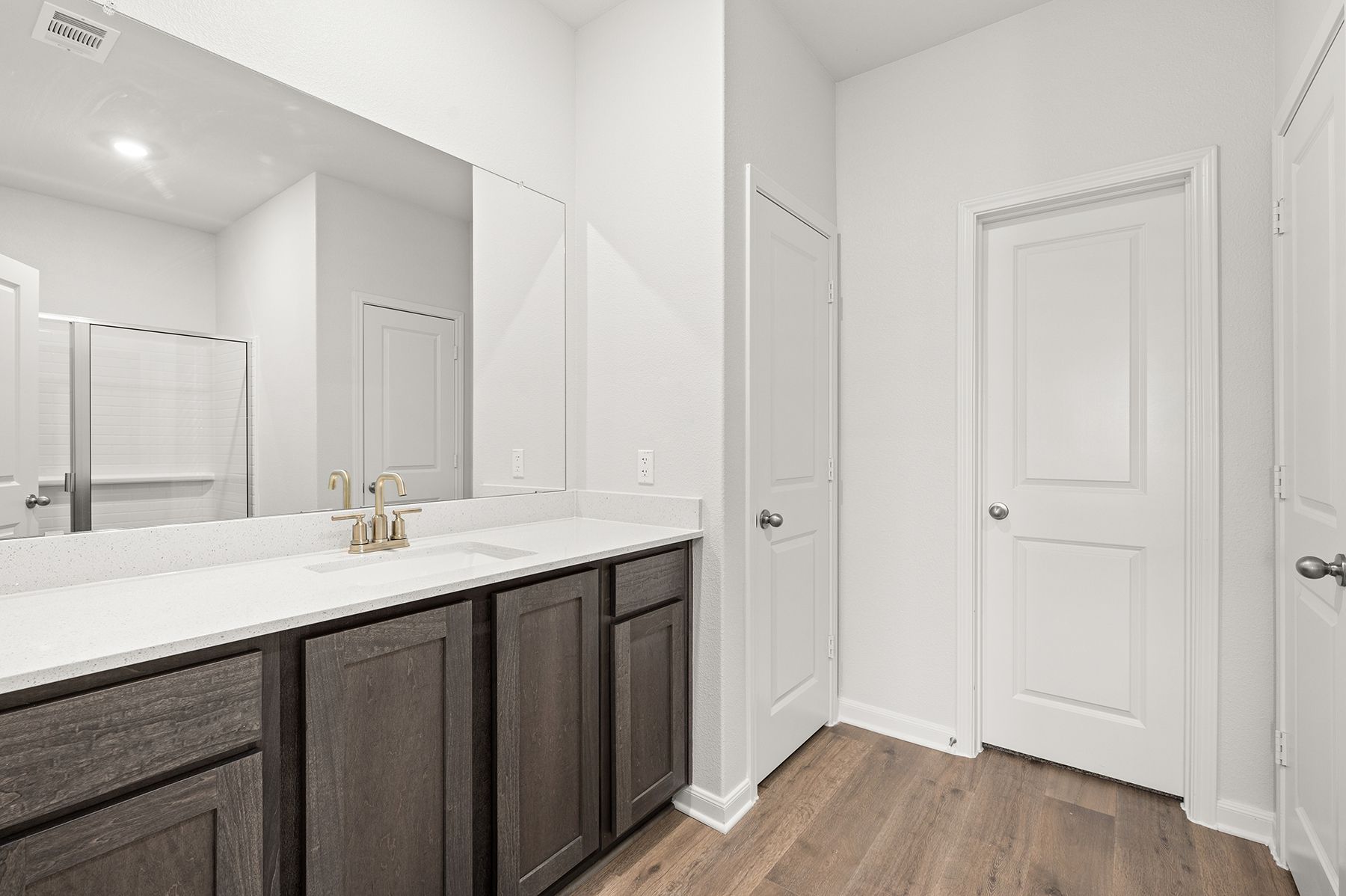 The master bathroom has a large vanity.