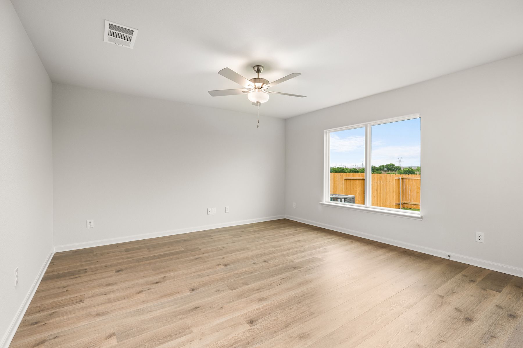 The family room is spacious and has a large window.