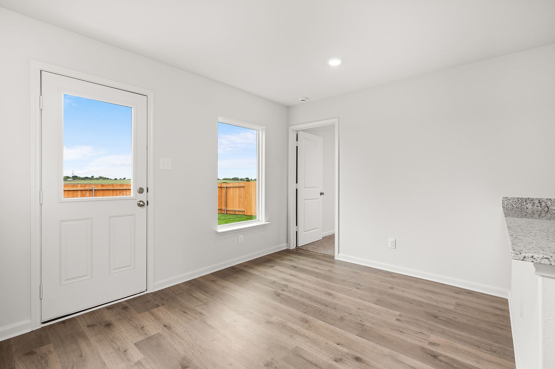 The dining room has large windows that let in great, natural light.