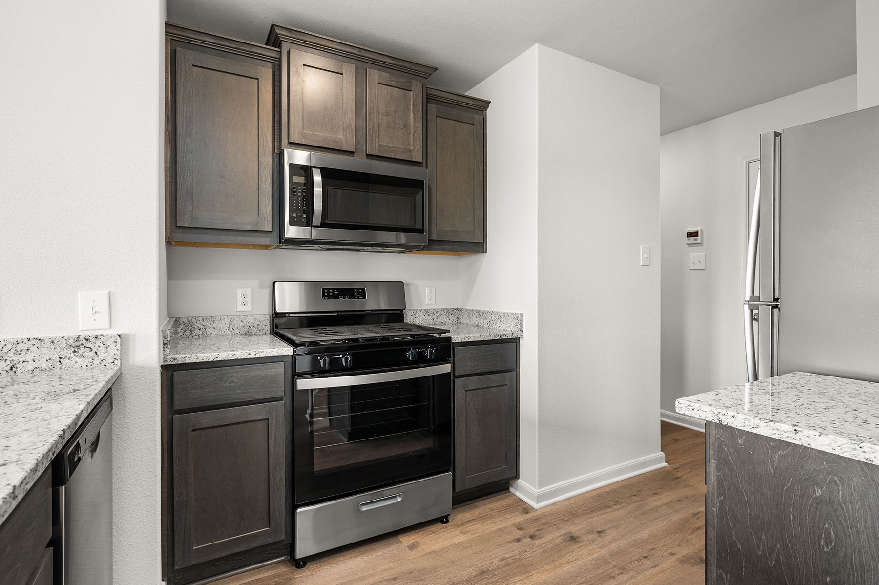 The kitchen has sprawling granite countertops.