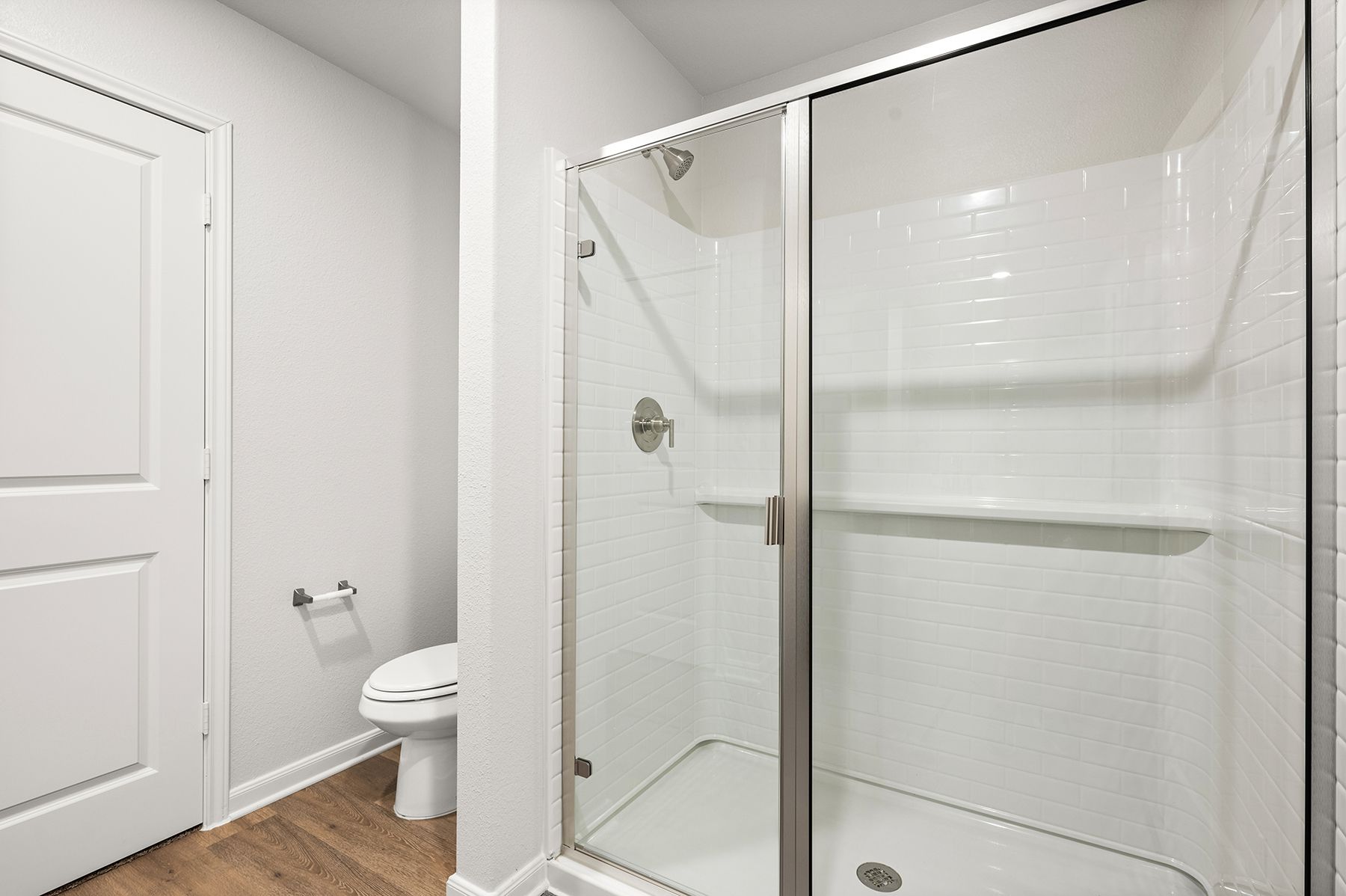 The master bathroom has a glass walk-in shower.