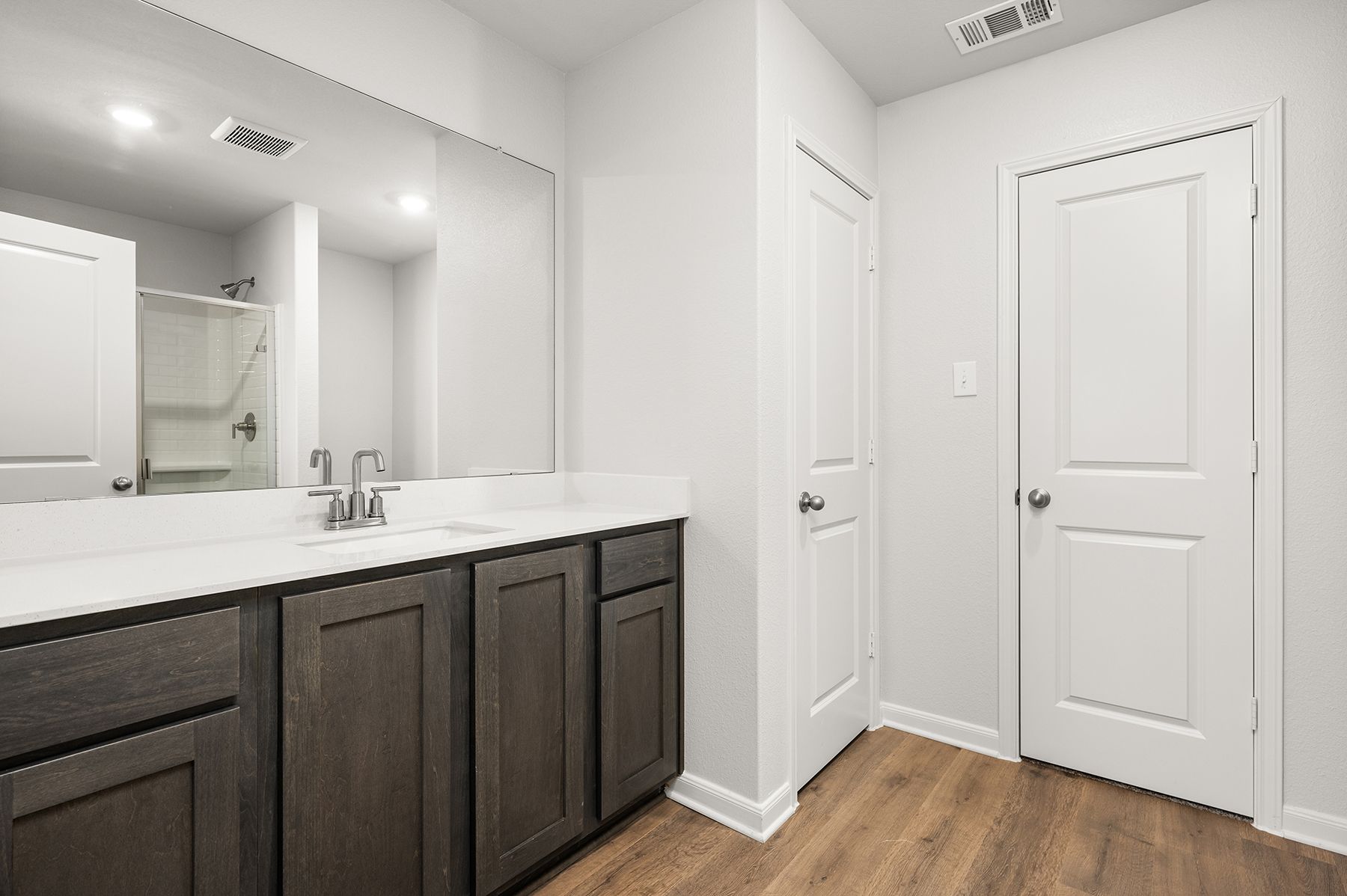 The master bathroom has a large vanity space.