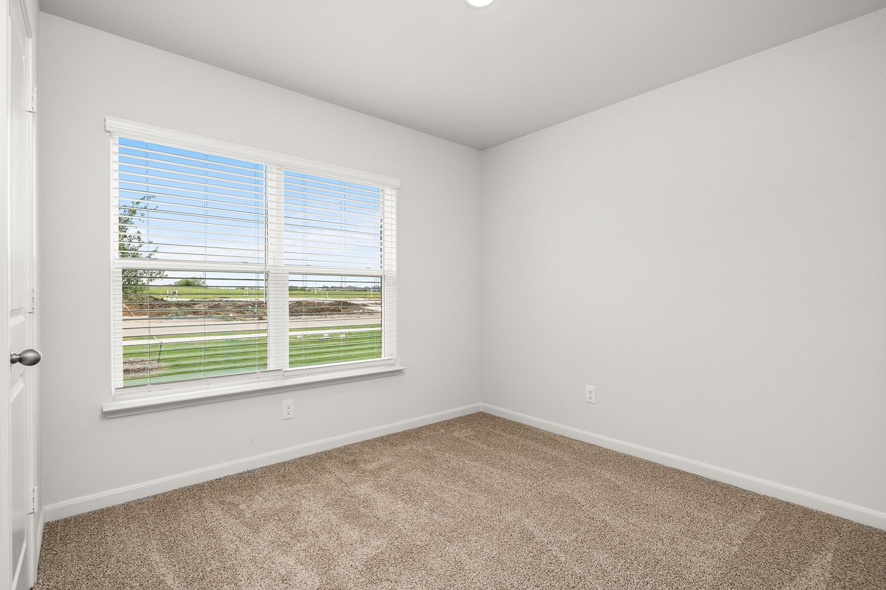 The master bedroom has a large window.