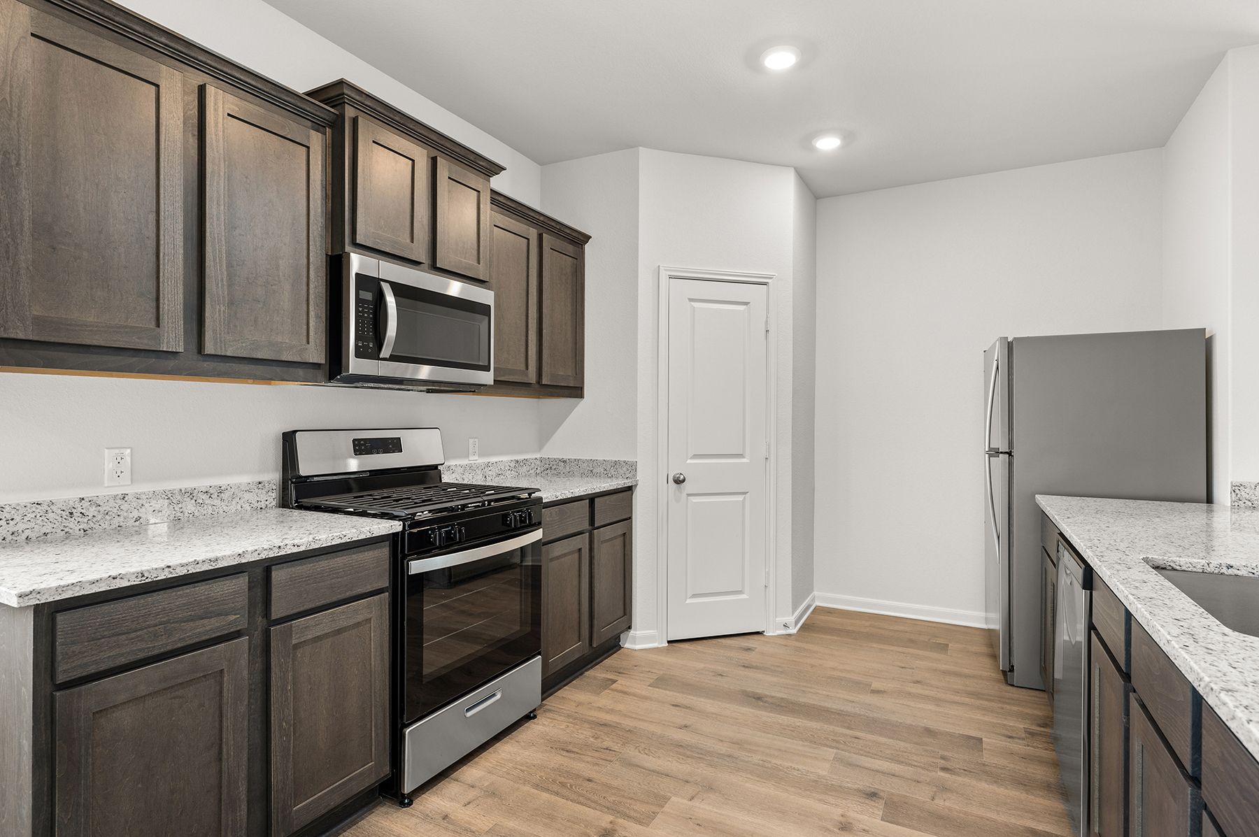 The kitchen has gorgeous wood cabinetry.