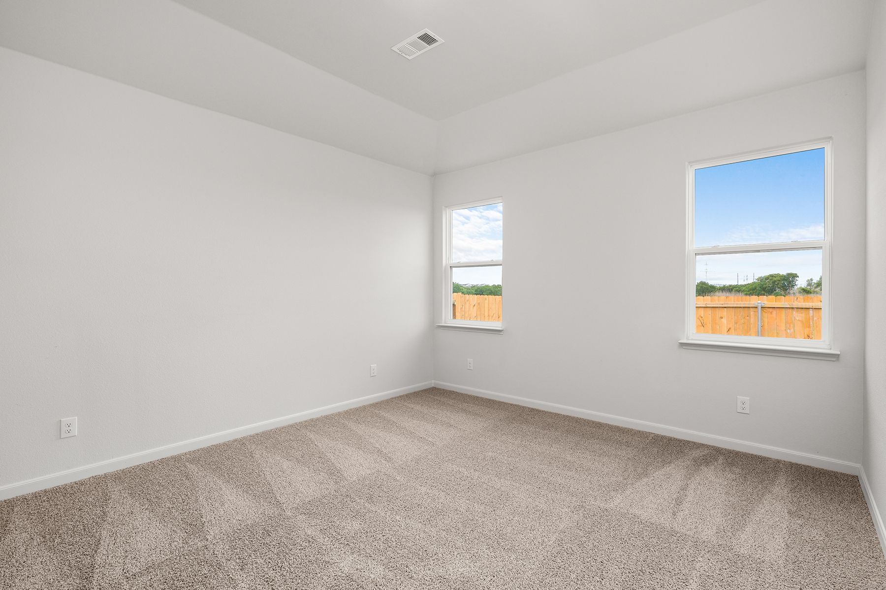 The master bedroom has two large windows.