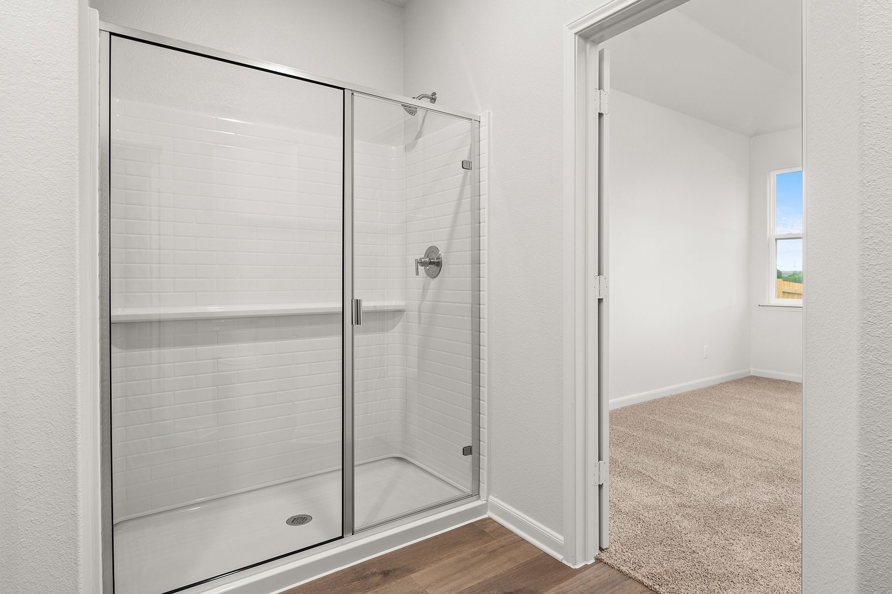 The master bathroom has a glass, walk-in shower.