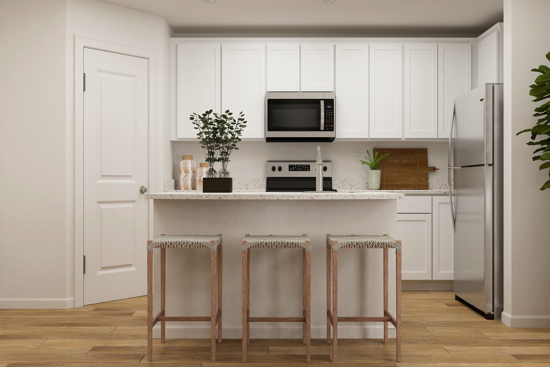 The kitchen of the Delano has beautiful white wood cabinetry and sprawling granite countertops.