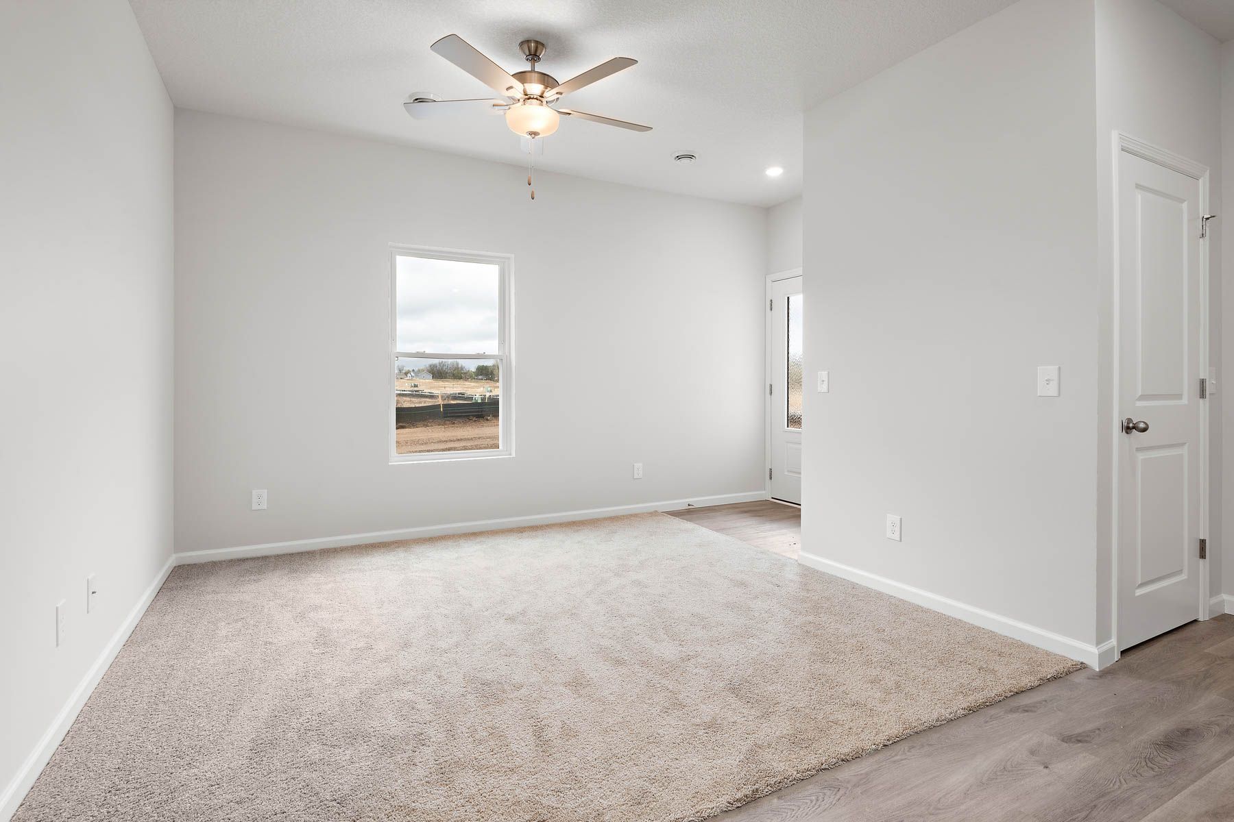The family room is spacious with a ceiling fan.