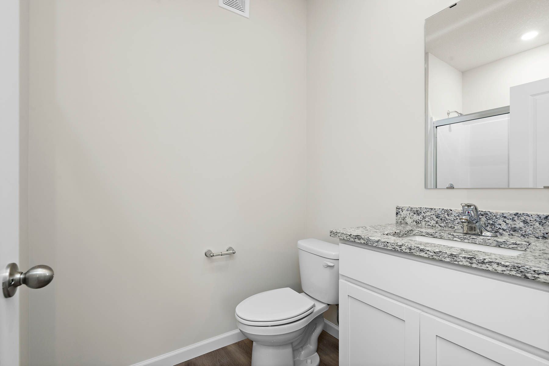 The master bathroom has a large vanity and step in shower.