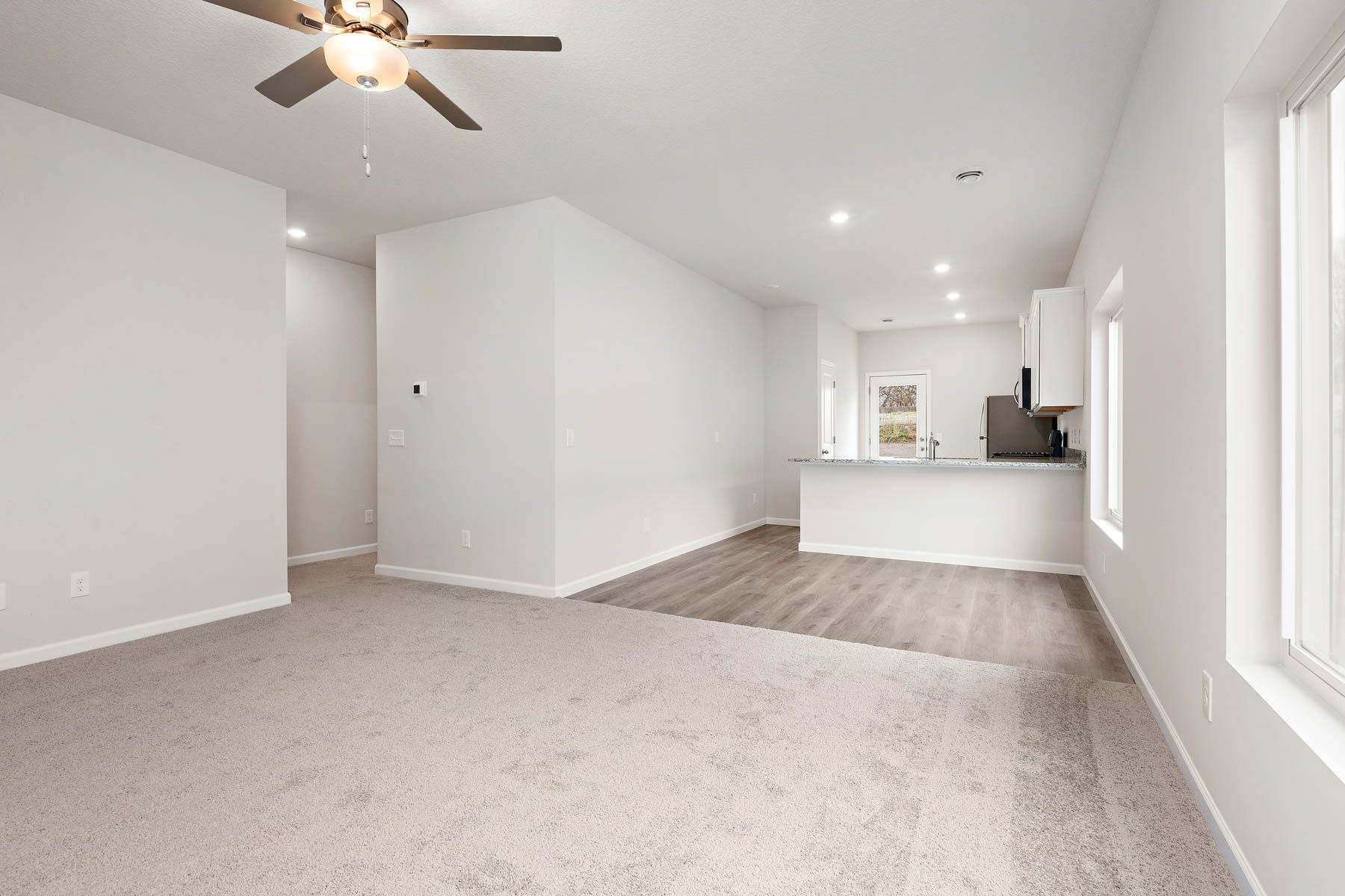 The family room is spacious with a ceiling fan.