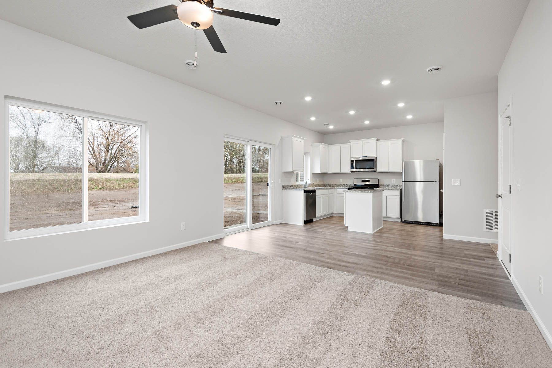 The family room is spacious with a ceiling fan.