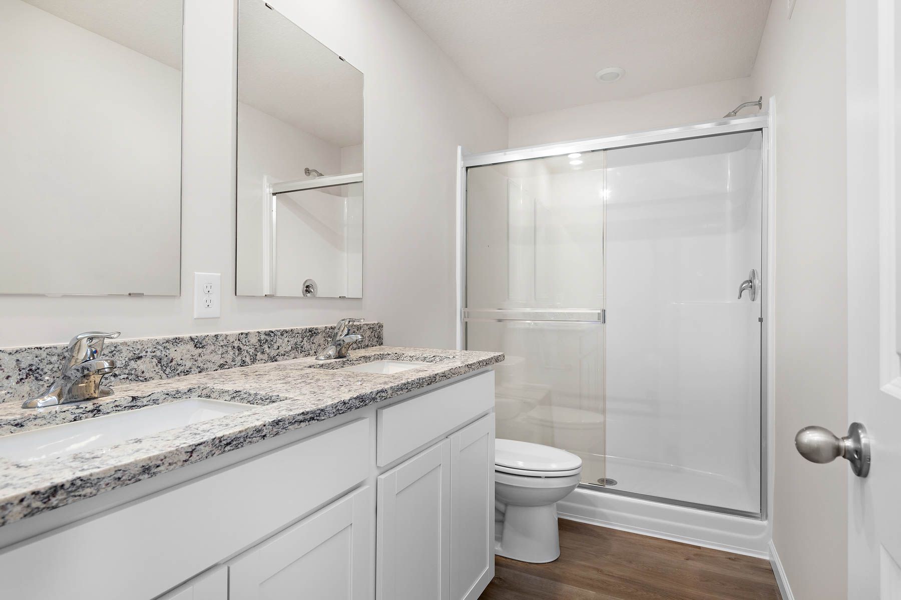 The master bathroom has a dual sink vanity.