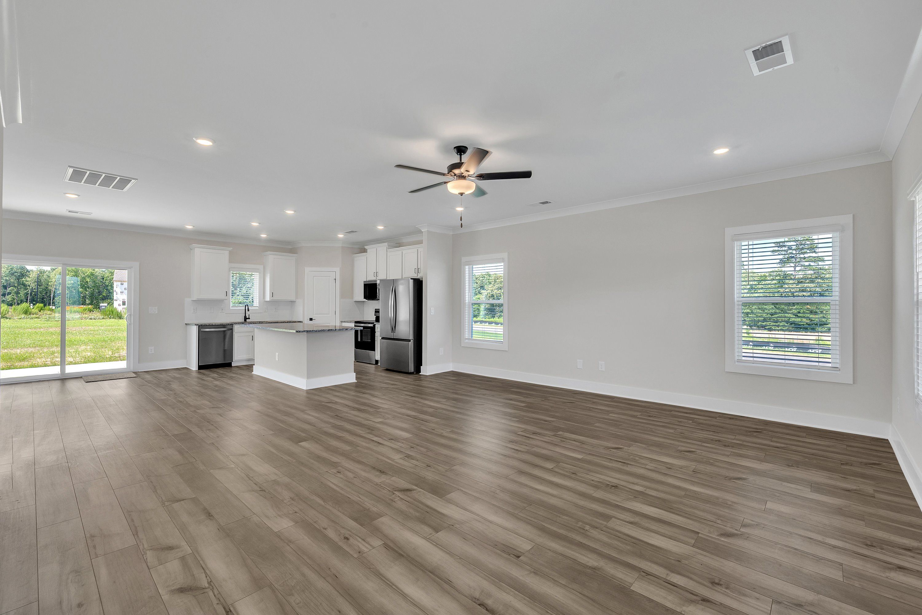 The living room has lots of windows and space, perfect for hosting. 