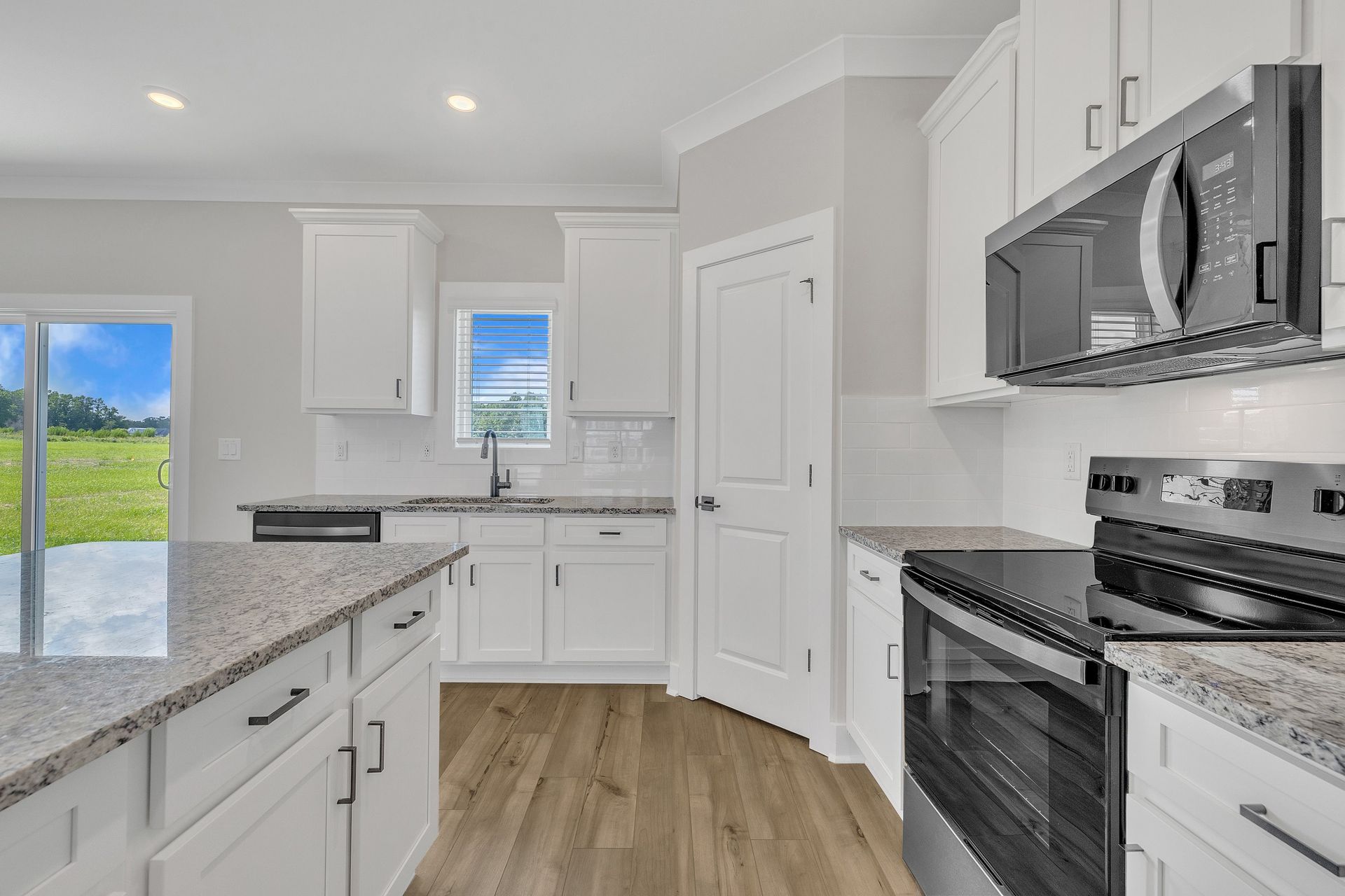 The kitchen has designer wood cabinetry. 