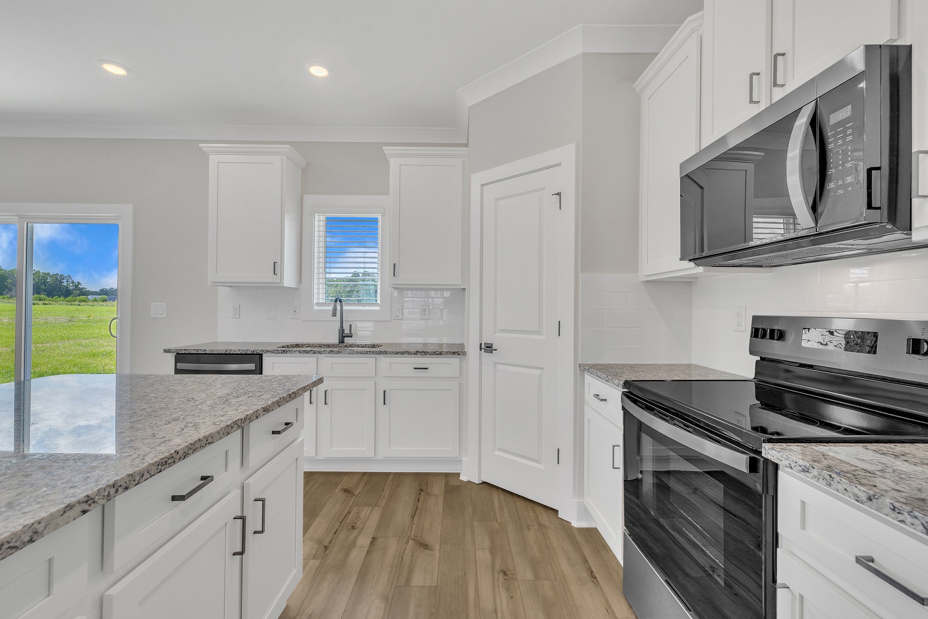 The kitchen has designer wood cabinetry. 