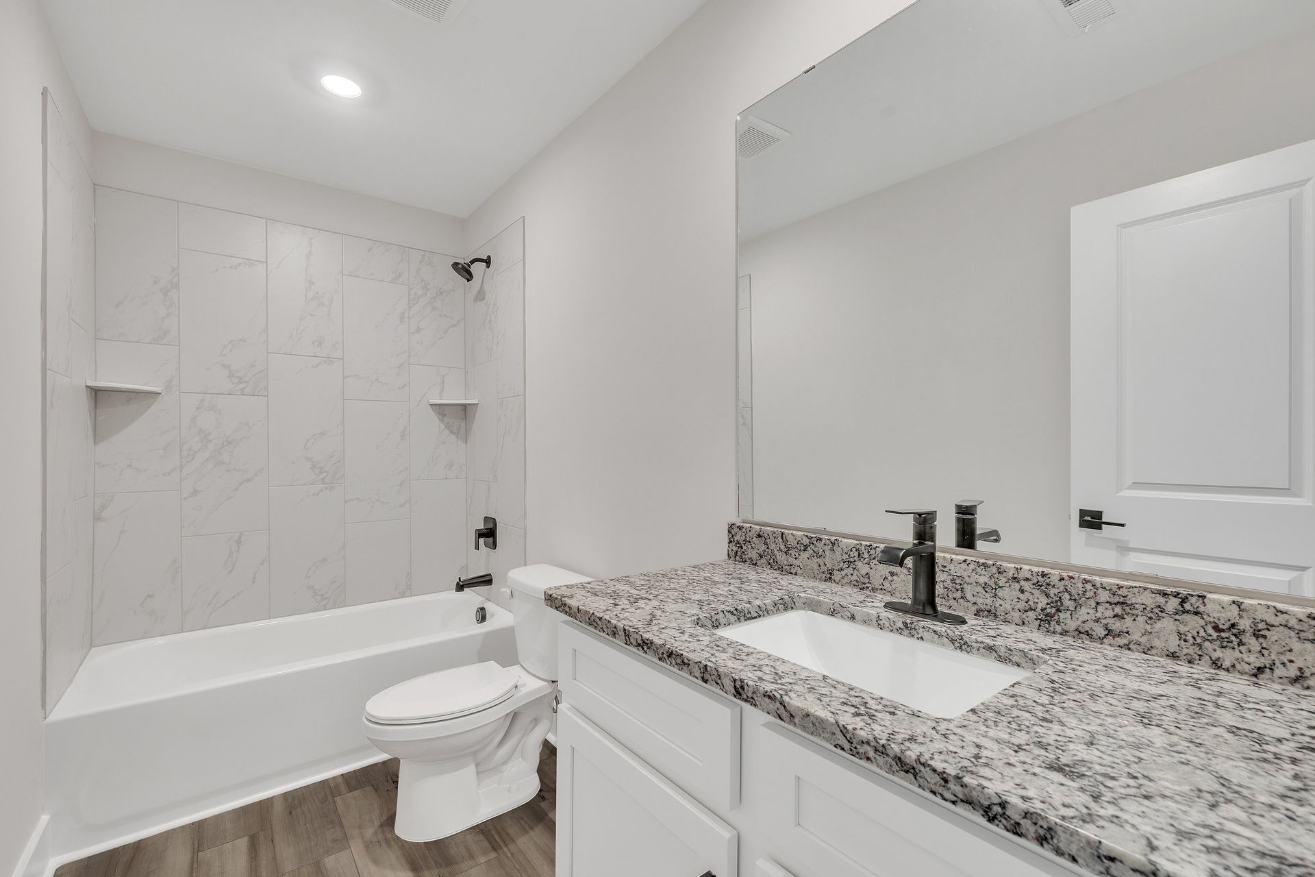 The secondary bathroom comes with a large soaking tub. 