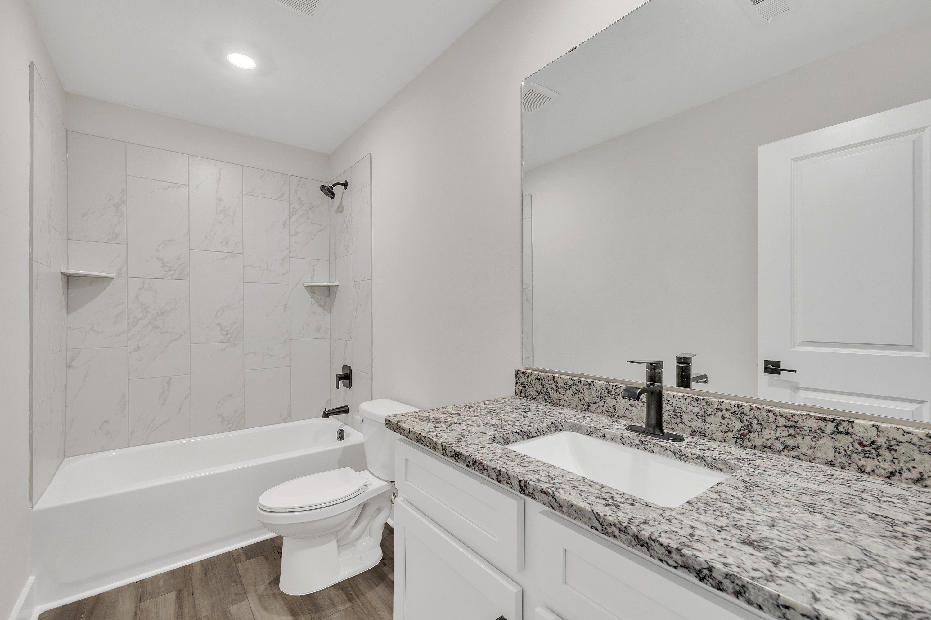 The secondary bathroom comes with a large soaking tub. 
