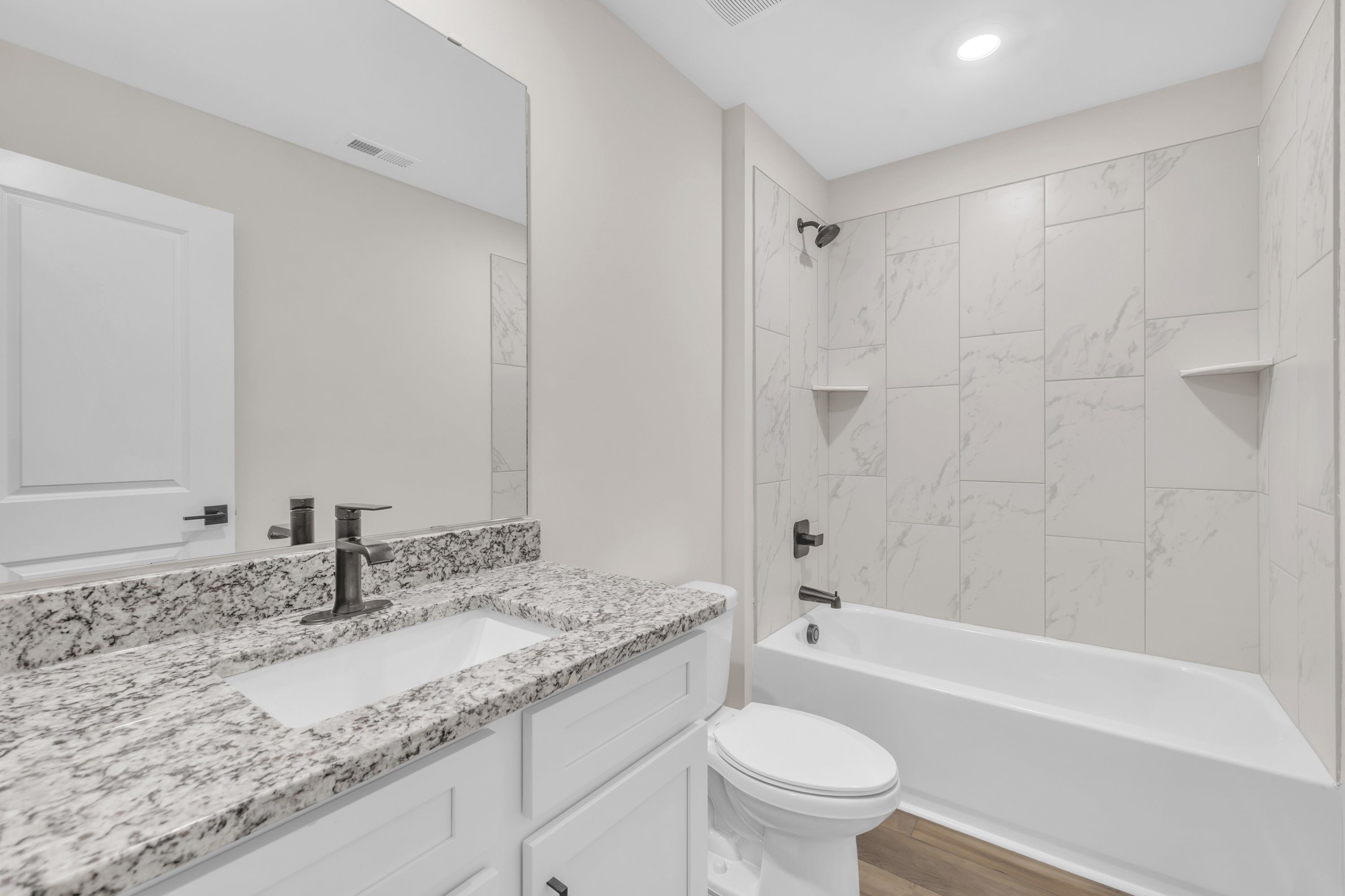 The secondary bathroom comes with a large soaking tub. 