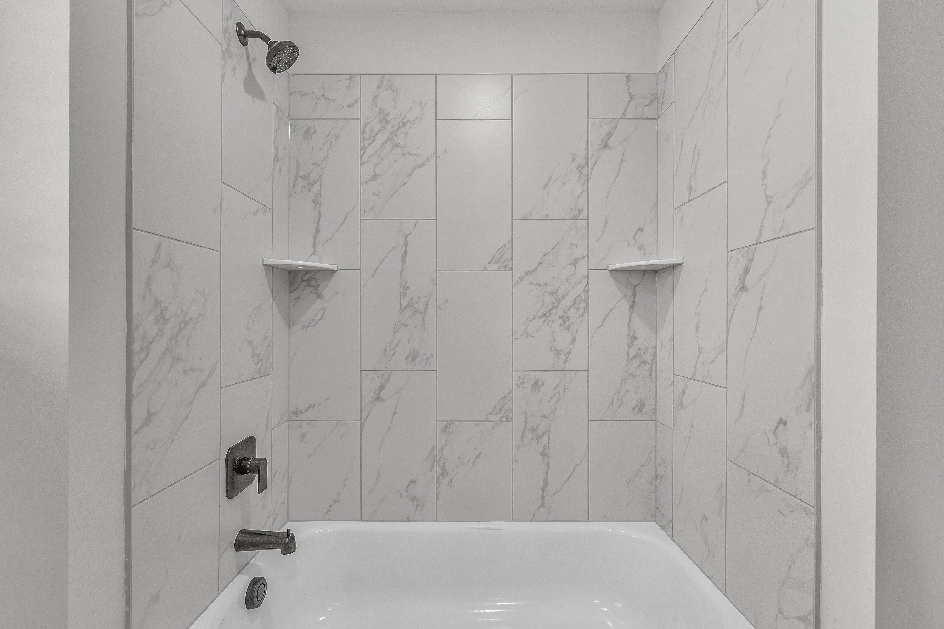The secondary bathroom has a large soaking tub.