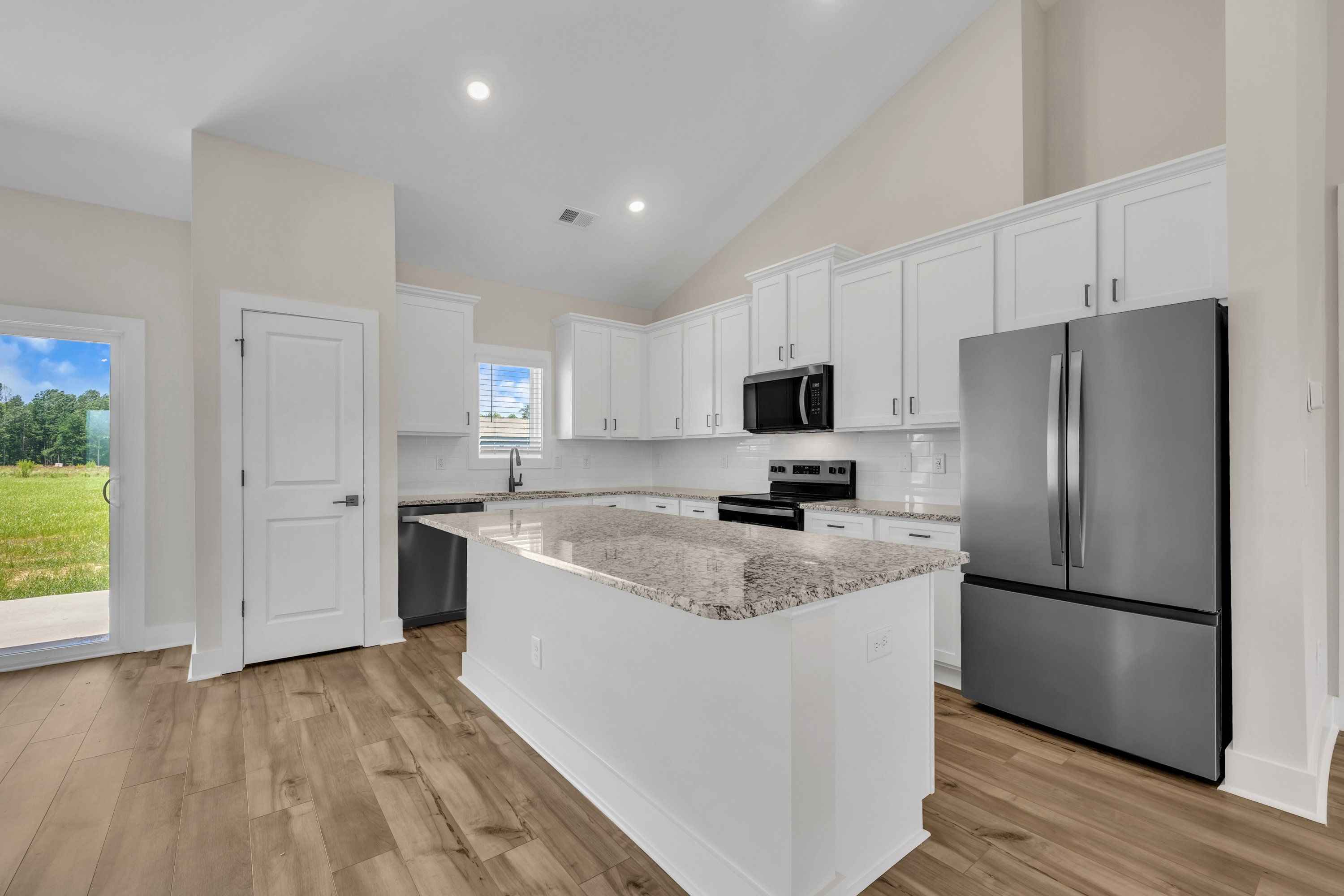 The kitchen has a spacious kitchen island. 