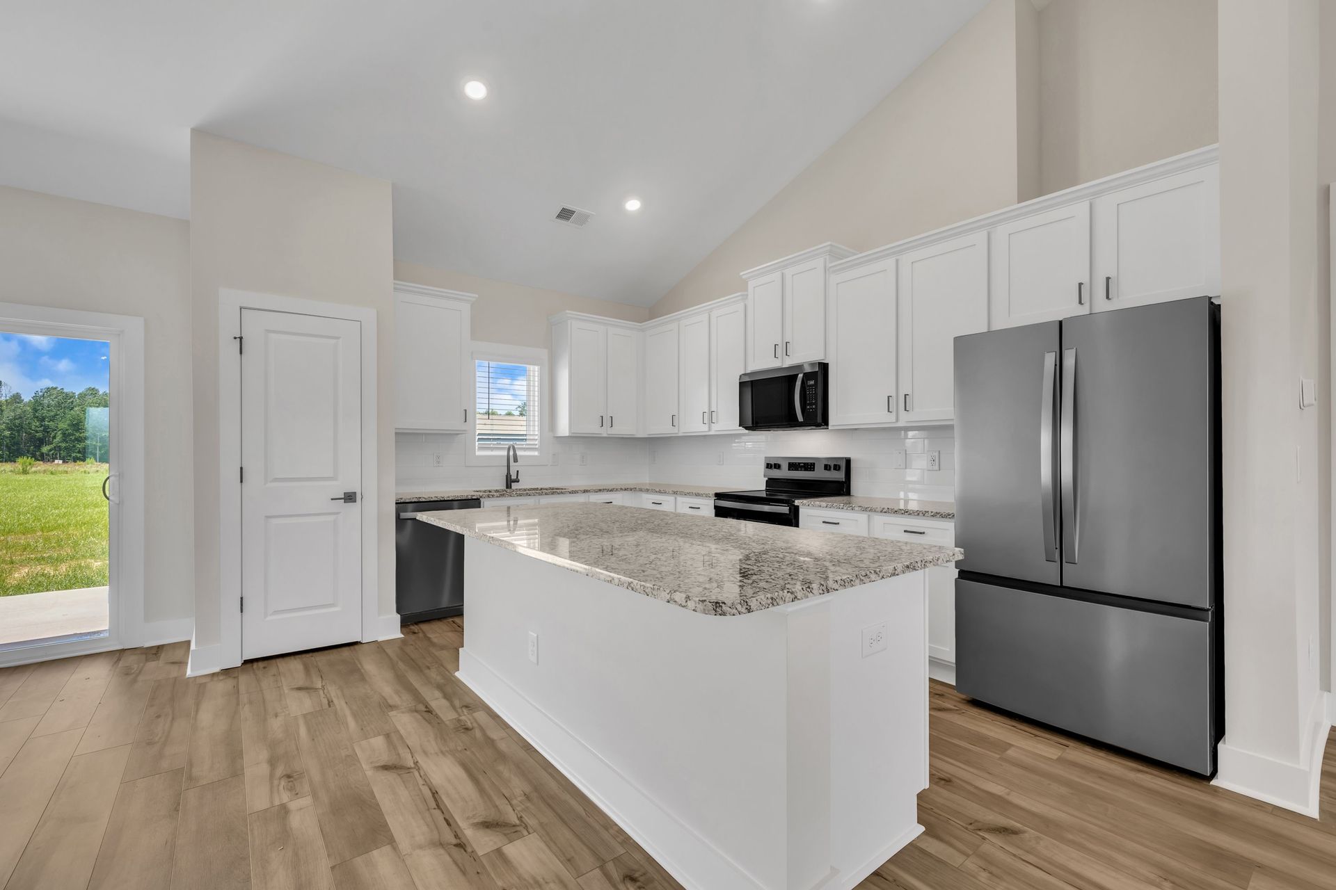 The kitchen has a spacious kitchen island. 