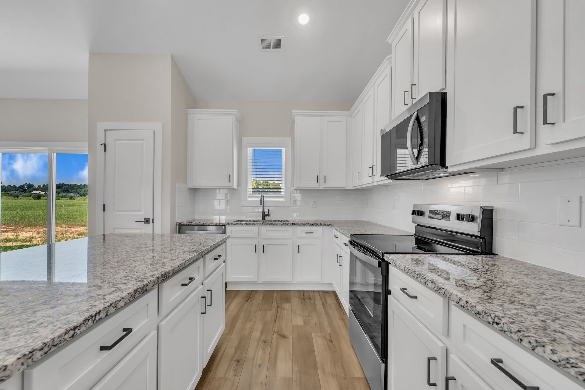 The kitchen has designer wood cabinetry. 