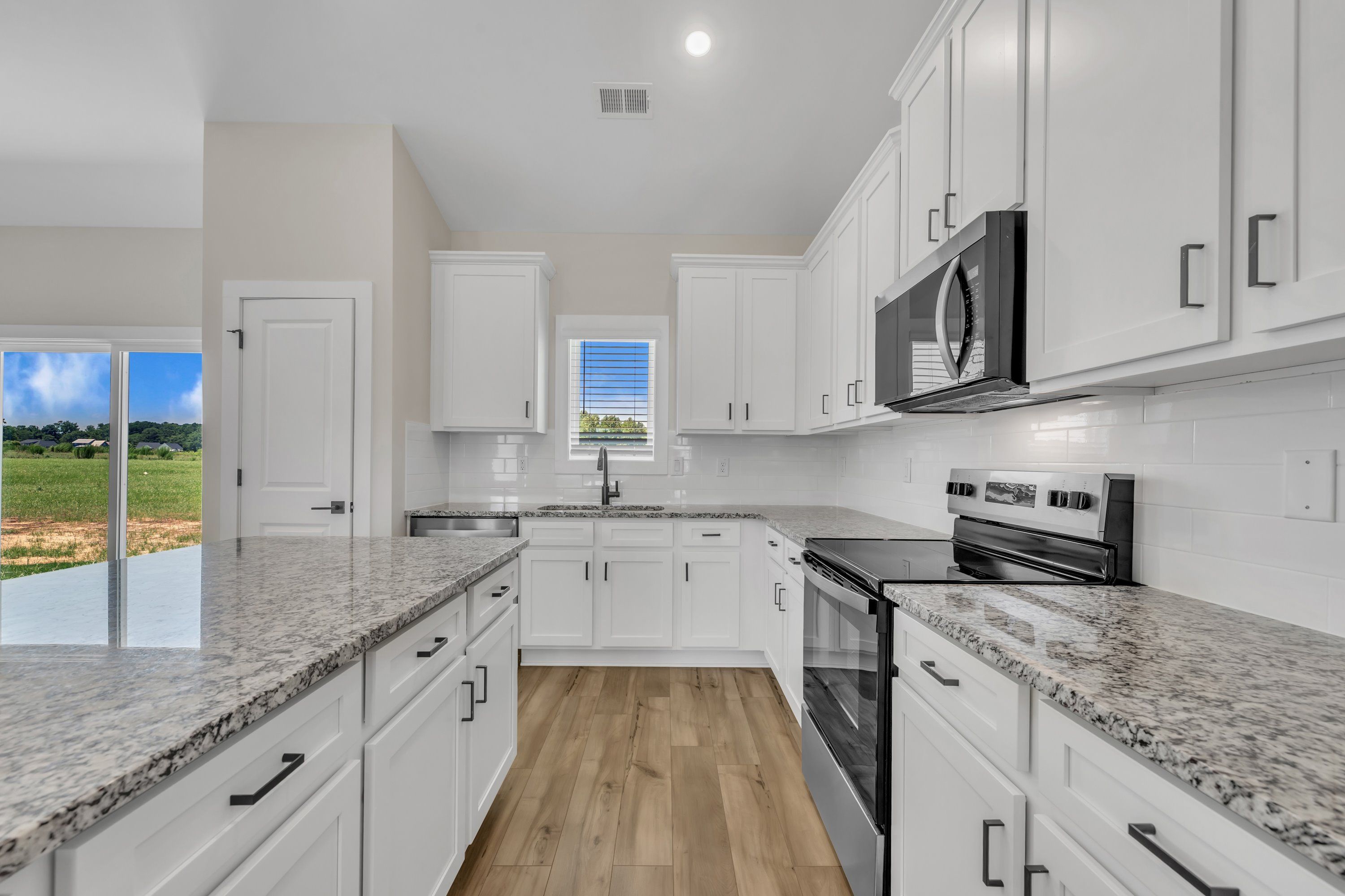 The kitchen has designer wood cabinetry. 
