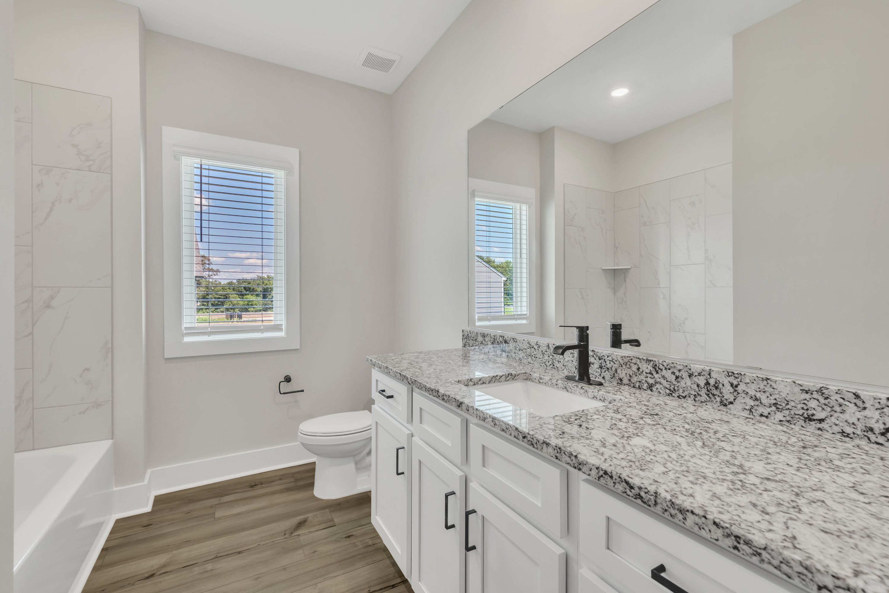 The secondary bathroom comes with a large soaking tub. 
