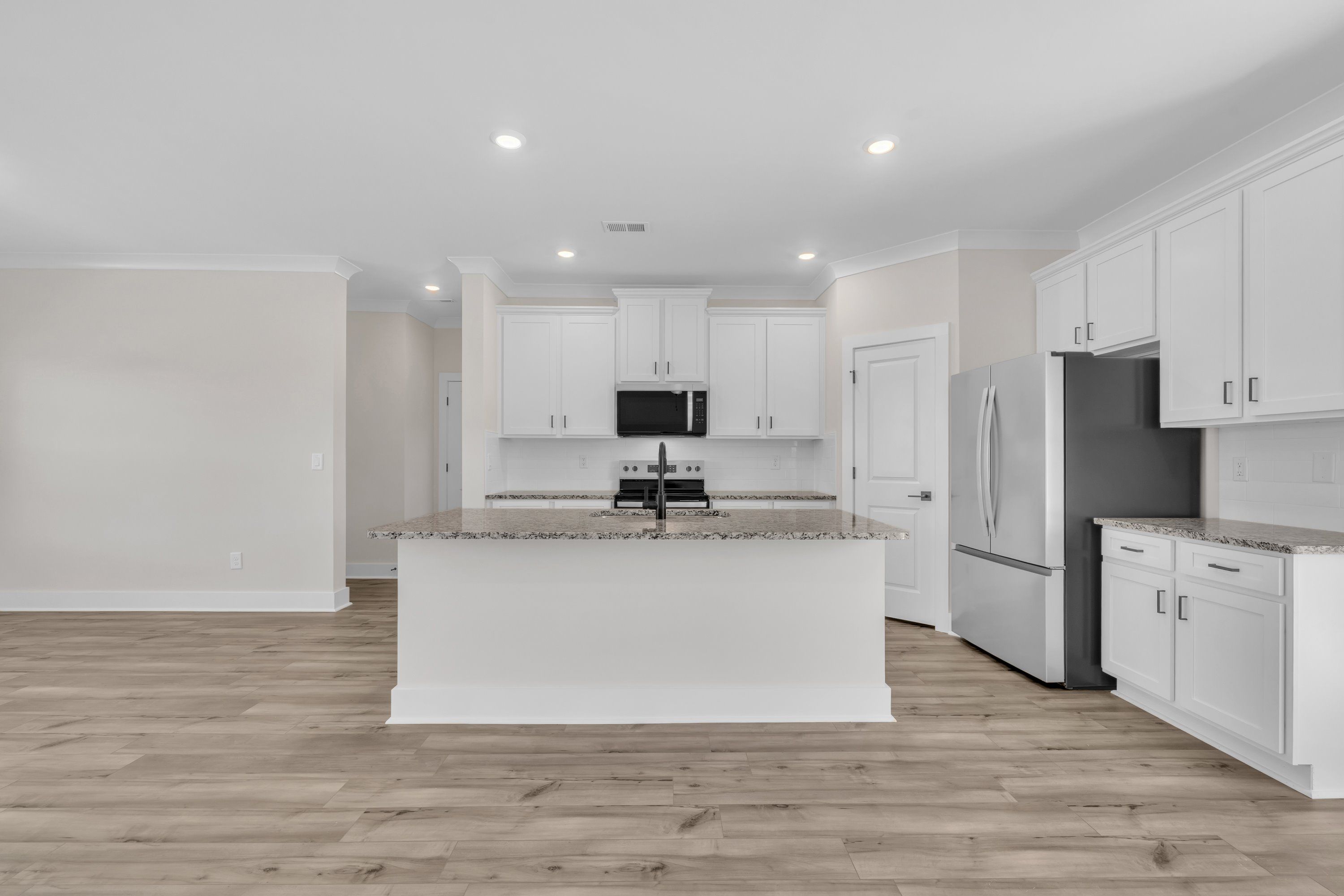 The kitchen has designer wood cabinetry. 
