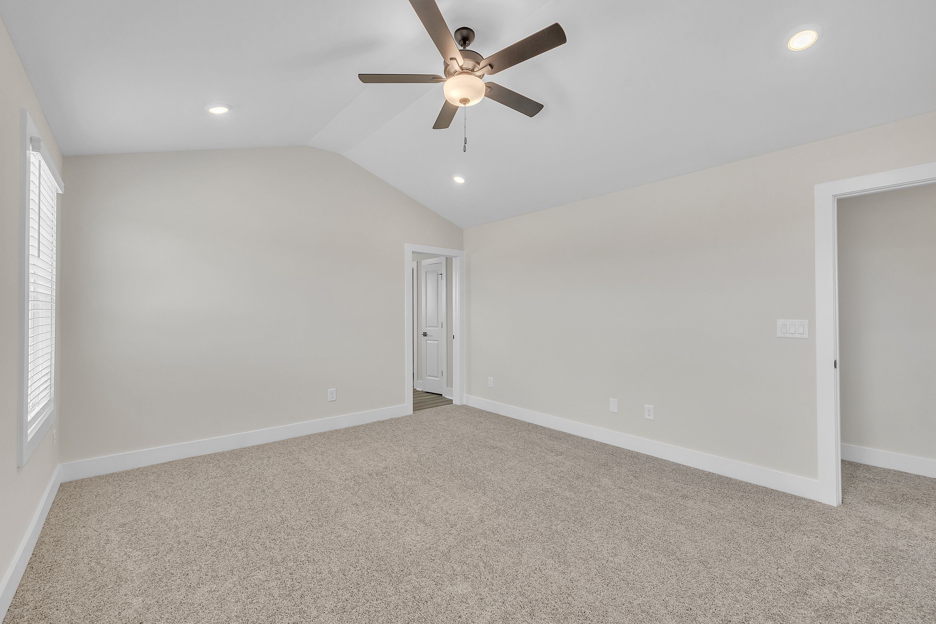 The master bedroom has lots of windows to let in natural light.