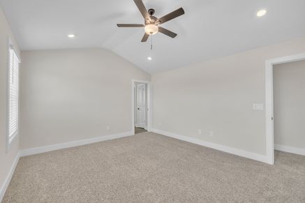 The master bedroom has lots of windows to let in natural light.