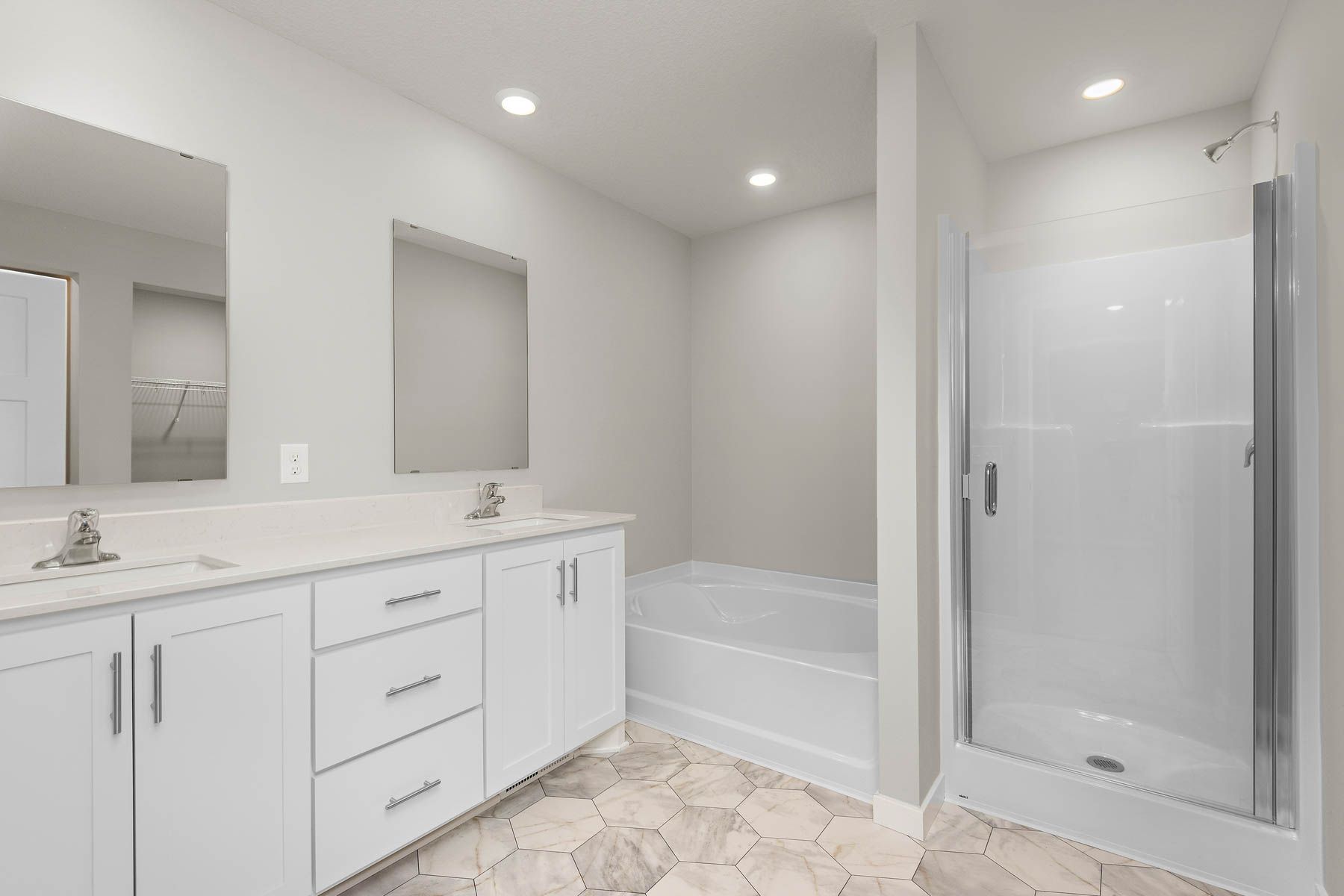 The master bathroom has a dual sink vanity and soaking tub and step in shower.