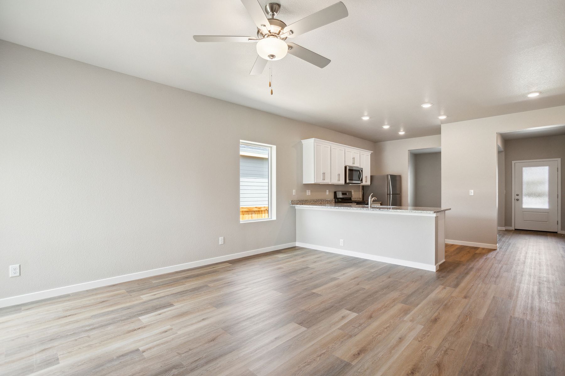 The family room is spacious with a ceiling fan.