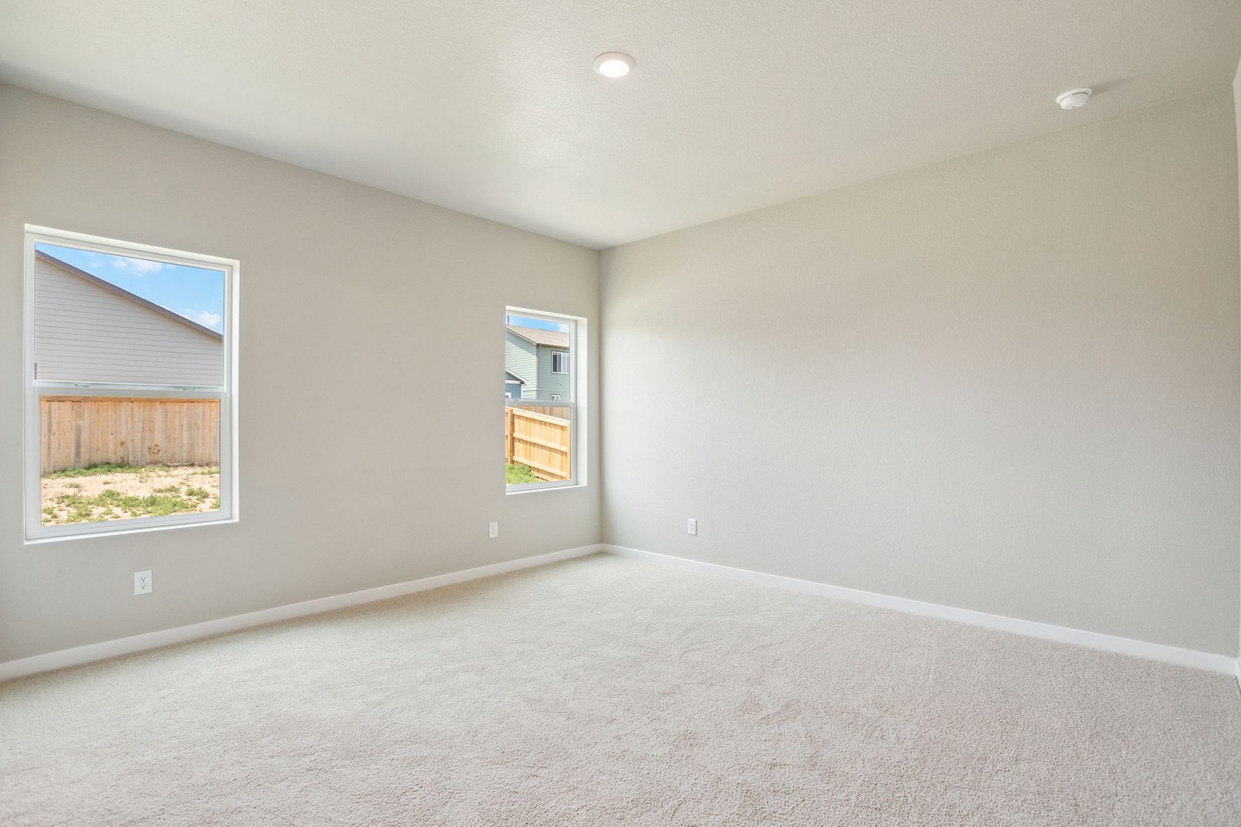 The master bedroom is spacious and has carpet.